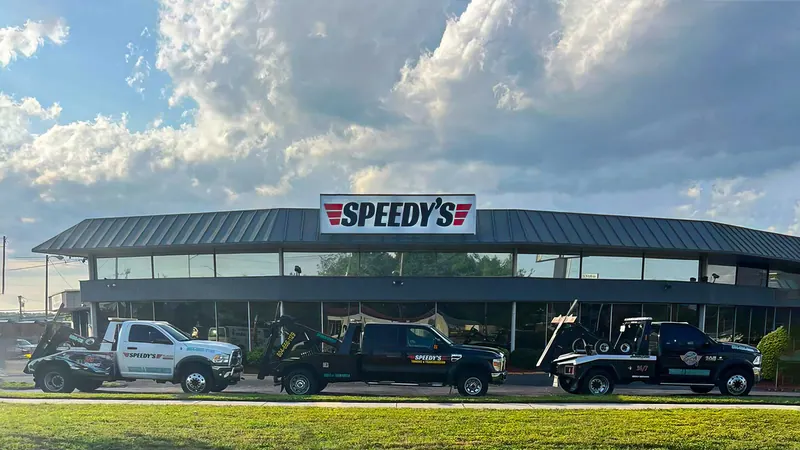Speedy's tow trucks parked in front of the shop